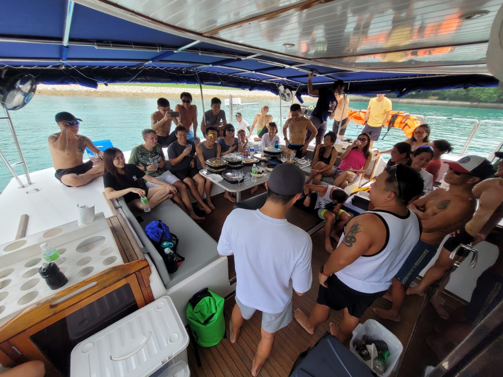Around twenty-five guests under the aft awning with a buffet laid out