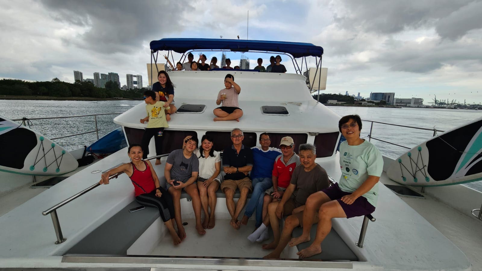A three-generation family across the foredeck lounge and coachroof