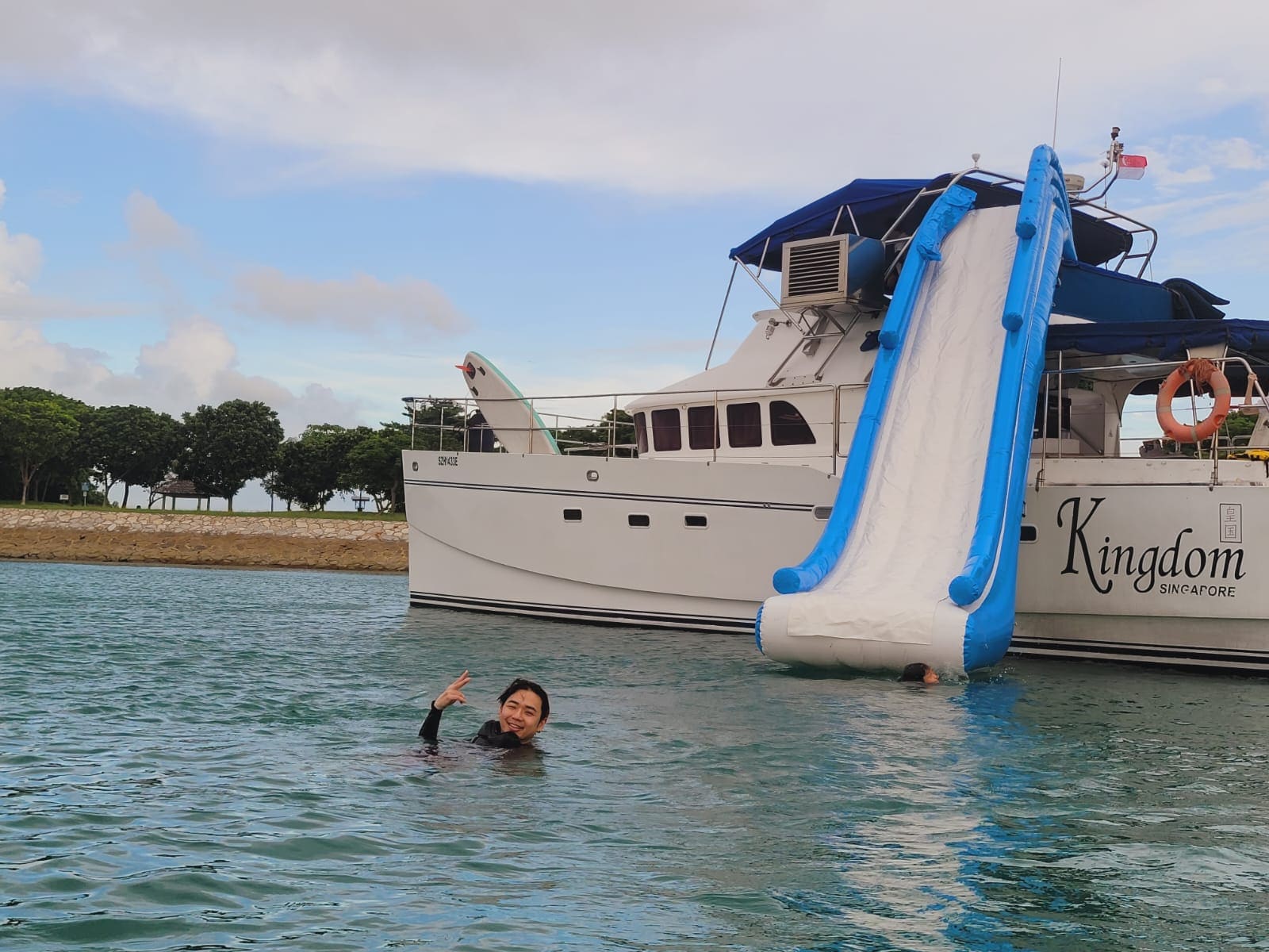 The five-metre slide reaching the water from the top deck, swimmer alongside