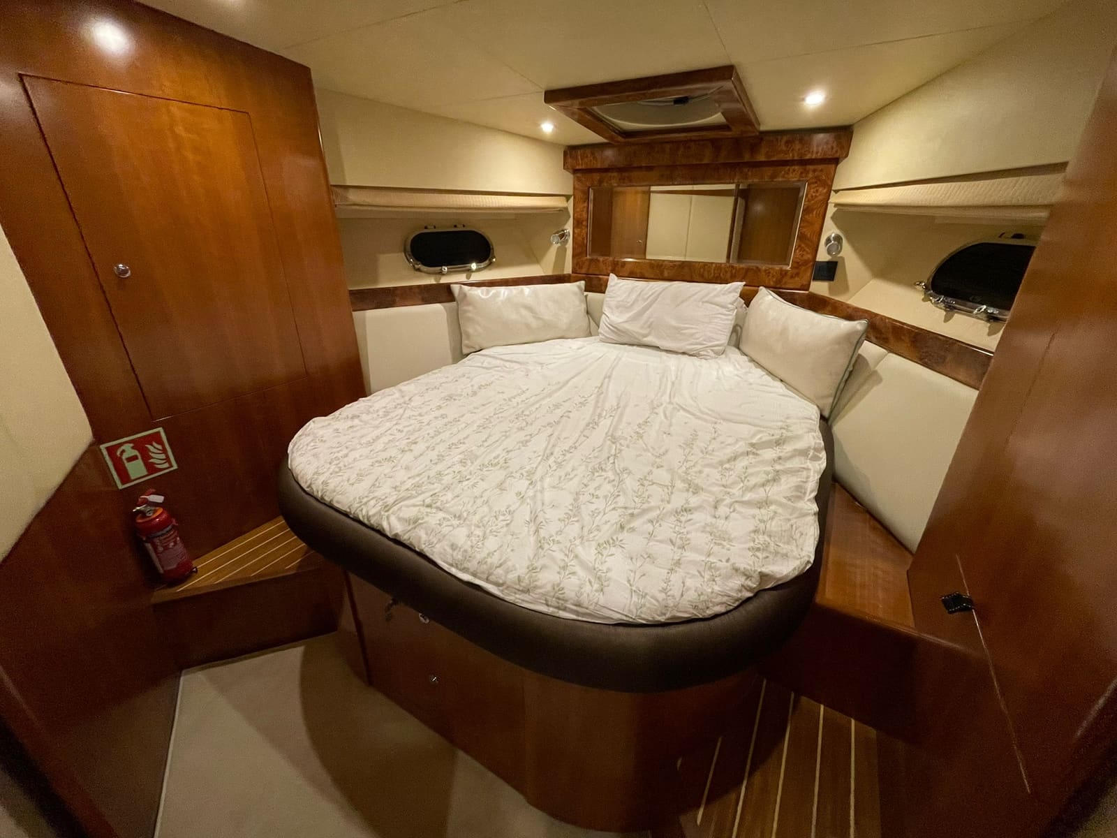 Master cabin forward, with a double berth, a porthole each side and a mirror over the headboard