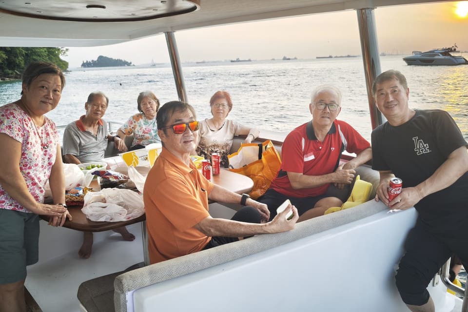 A family around the covered aft deck's cushioned benches at golden hour