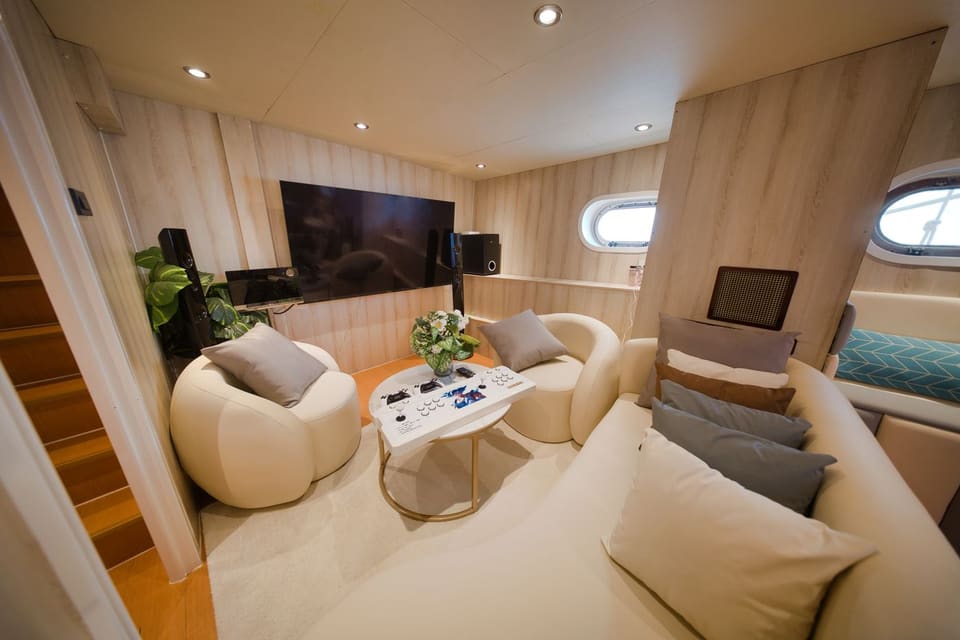 Lower-deck lounge with the wall television, hi-fi speakers and games-console table