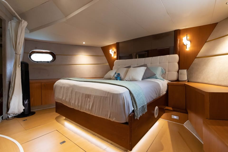 The bow stateroom's double bed with an upholstered headboard
