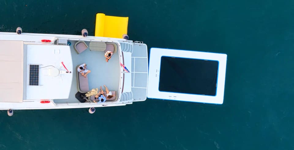 Overhead view of the upper aft deck with the floating trampoline and pool alongside