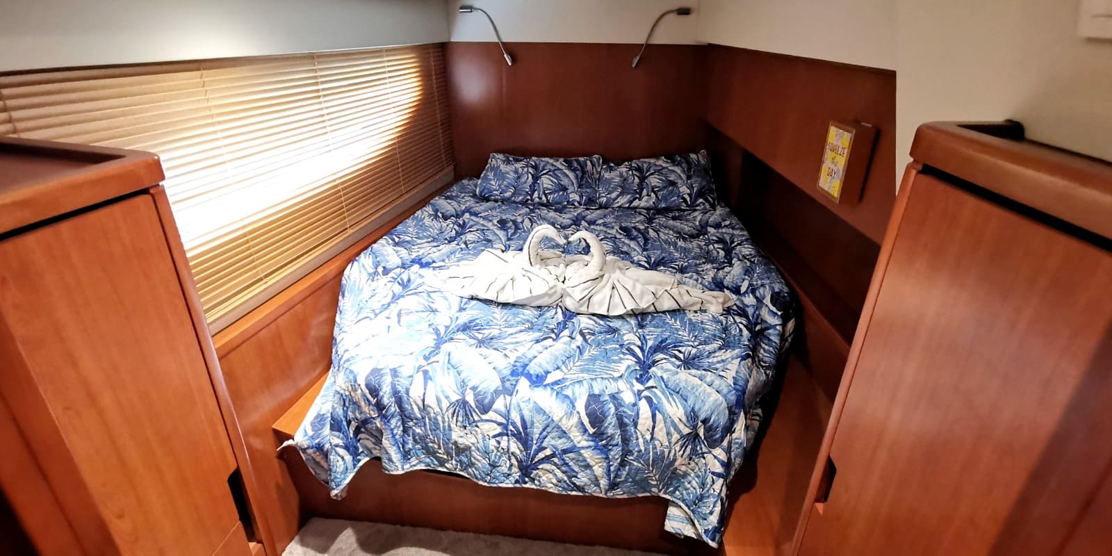 The second cabin, with a double berth under a long hull window with blinds