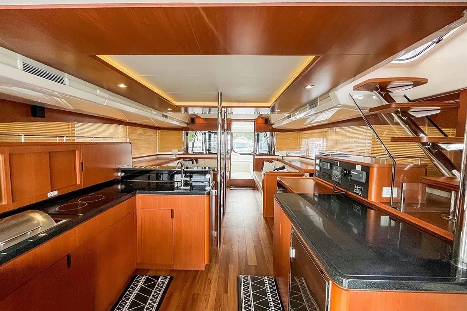 Air-conditioned saloon looking forward, with the galley worktops to port and the helm station beyond